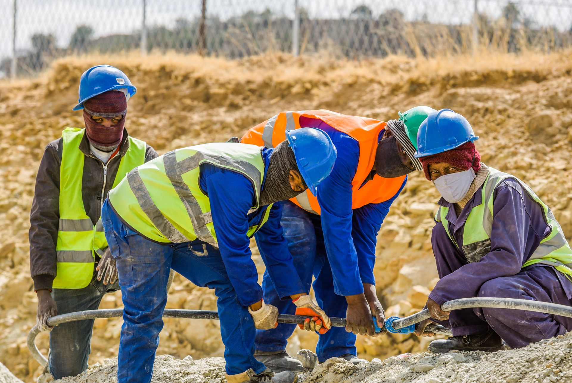 South African construction workers wearing protective equipment on site